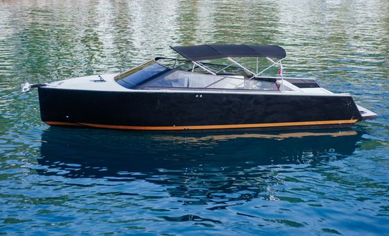 Side profile of a stylish black luxury motor yacht on the Adriatic Sea